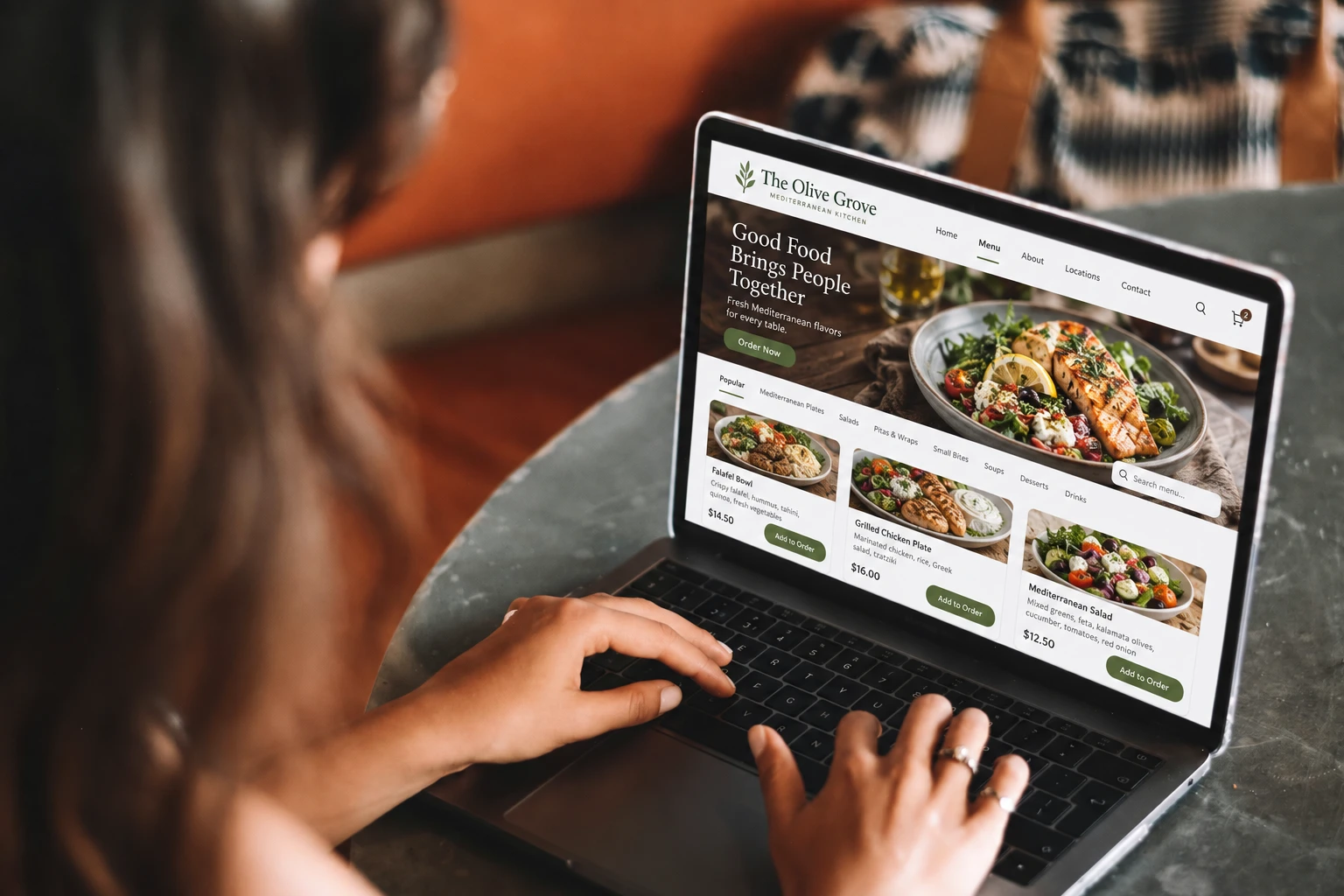 A guest browsing a restaurant's own website and menu on a laptop
